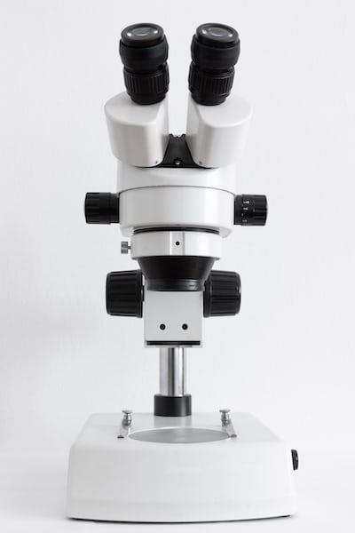 A microscope symbolizing the importance of assessing your assets in vulnerability management